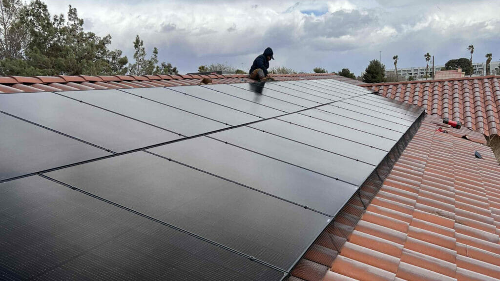 Bob's Repair technician expertly installing solar panels, contributing to renewable energy solutions.