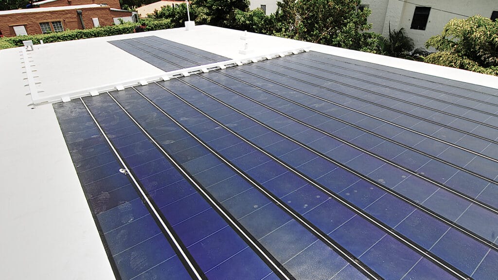 Flexible thin-film solar panels installed on a flat rooftop, demonstrating their lightweight and adaptable design.