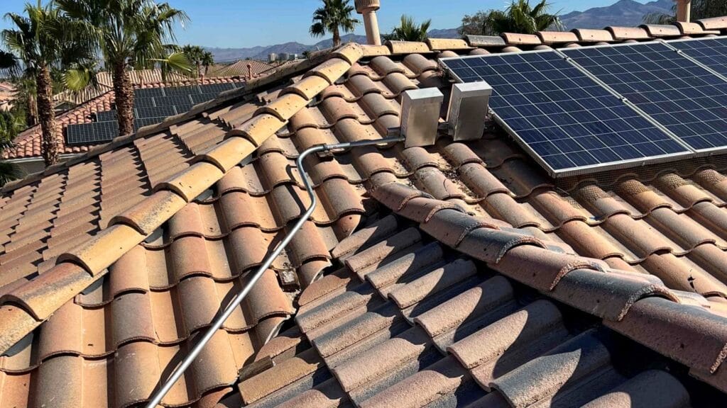 Rooftop solar panel installation on a tile roof in Las Vegas, with visible electrical conduit and junction boxes ensuring proper system functionality