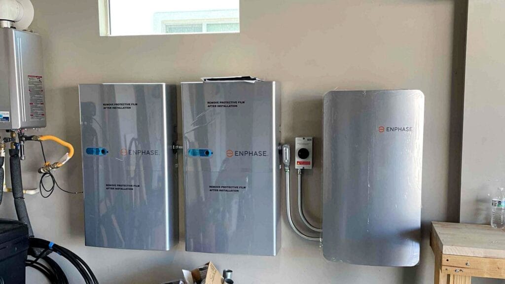 Installed Enphase battery storage system inside a residential garage for solar energy backup