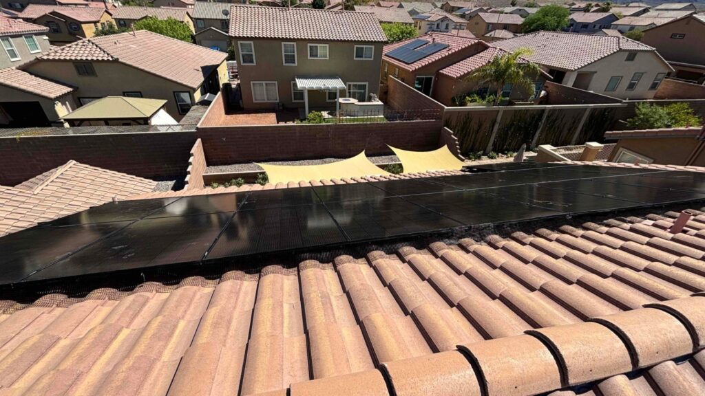 Bob's Repair desert solar panel installation across a tile roof in a Las Vegas Valley neighborhood, with surrounding stucco homes visible